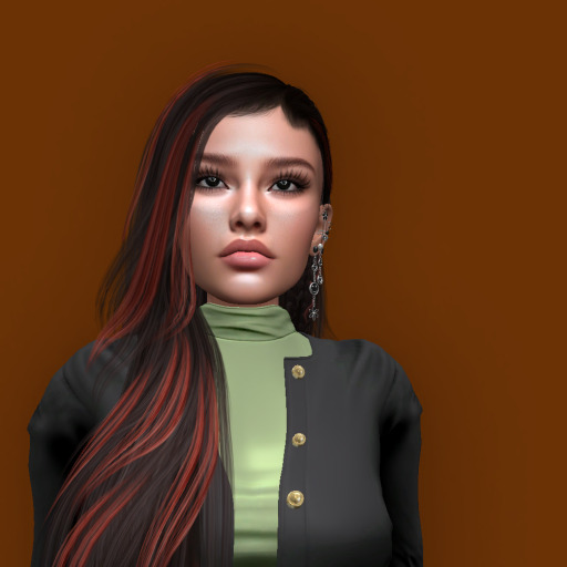 A young woman with long, dark hair featuring reddish highlights. She has a neutral expression and is wearing a black jacket over a green top. The background is an orange hue.