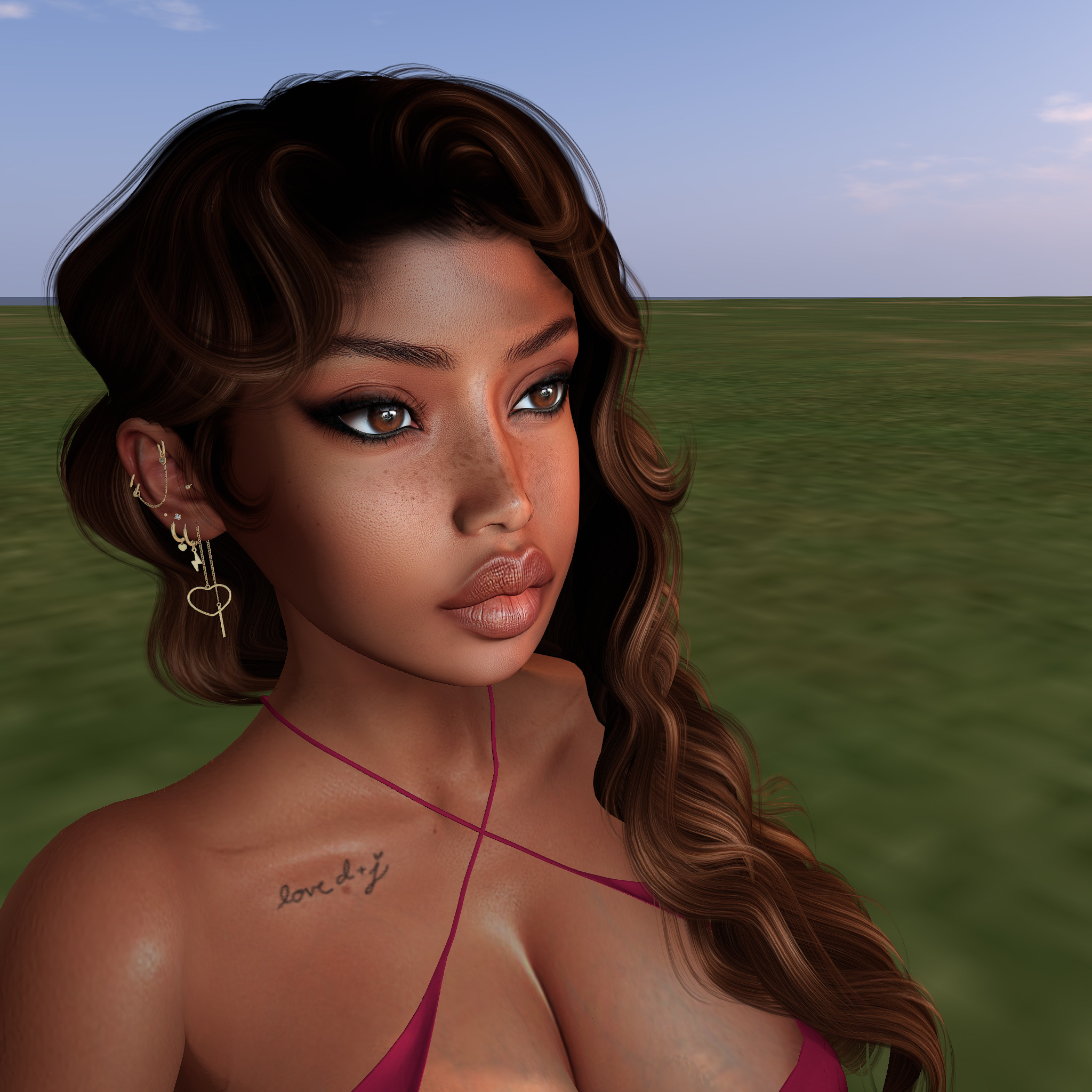 A close-up portrait of a young woman with long, wavy dark hair and prominent makeup. She is wearing a red halter top and has a tattoo on her collarbone. The background features a grassy landscape under a clear sky.